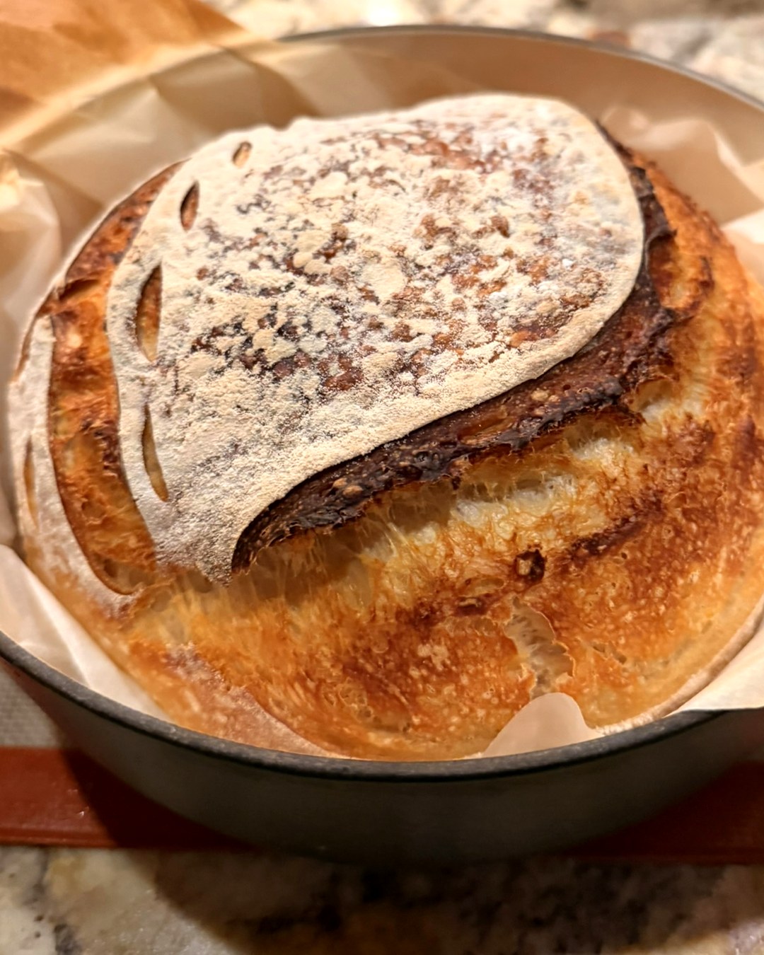 A rustic sourdough loaf with a floured, scored crust