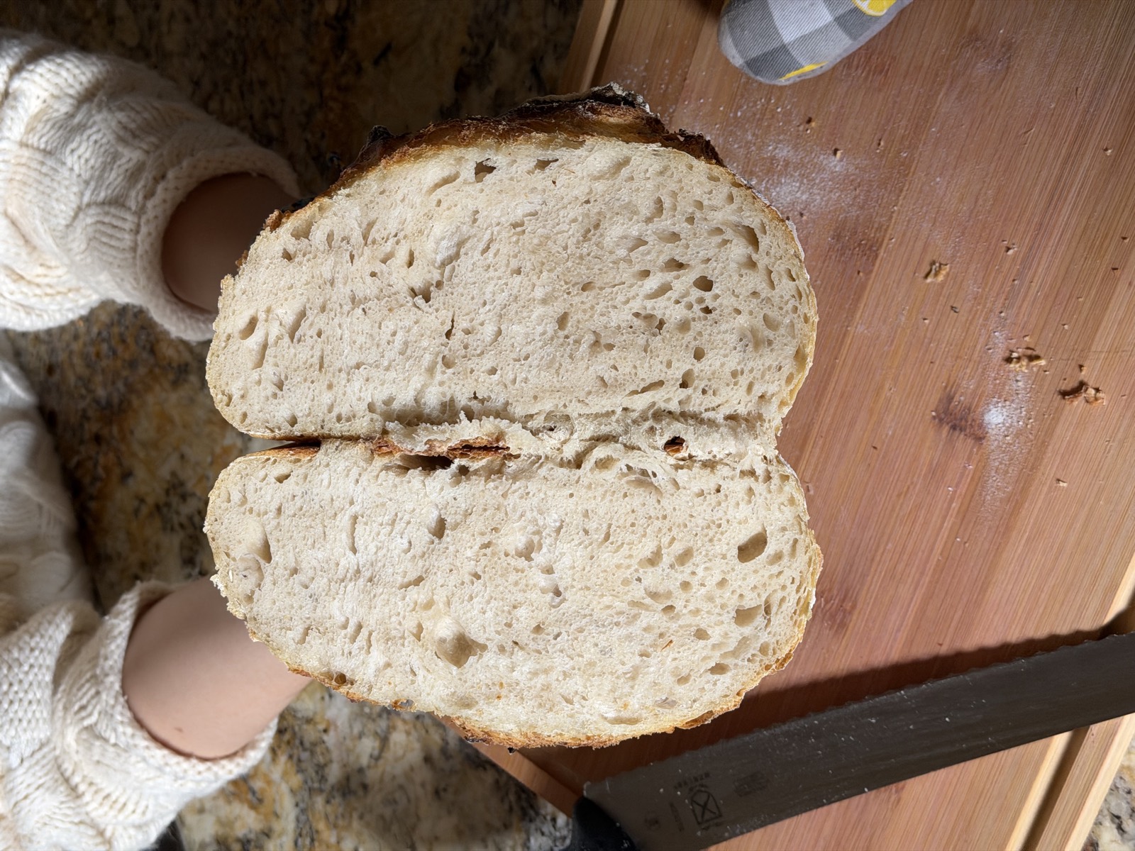 A sourdough loaf cut open to show the soft, airy crumb